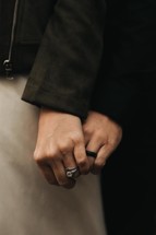 a married couple holding hands 