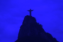 The Christ the Redeemer statue on top of the Corcovado mountain in Rio de Janeiro at dawn