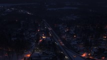 Aerial view of traffic on a highway during a snowy winter night