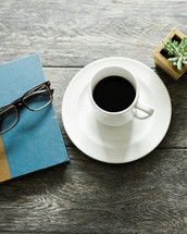 reading glasses, book, coffee, cup, saucer, house plant, succulent 