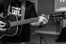 teen boy playing an acoustic guitar 