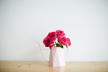 roses in a watering can 