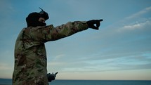Drone pilot soldier points to the target