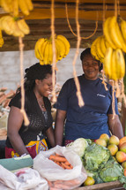 hanging bananas and a smiling vendor 