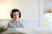 boy listening to headphones 