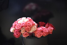 pink roses in a metal bucket 