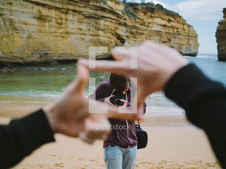 finger frame around a man taking a picture 