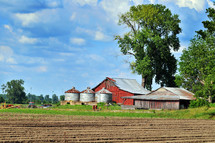 Farm with a barn and silos.