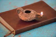 Burning oil lamp pm a Holy Bible.