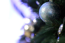 A Christmas ornament hanging on a Christmas tree.