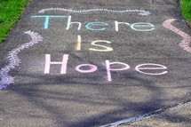 An uplifting chalk art message "There is Hope" on our driveway