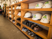 construction helmets and boots on a shelves 