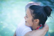 pastor hugging a woman after her baptism 
