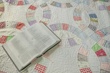 opened Bible on a quilt 