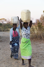 a woman balancing water on her head 