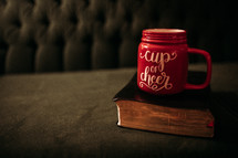 cup of cheer mug on a Bible 