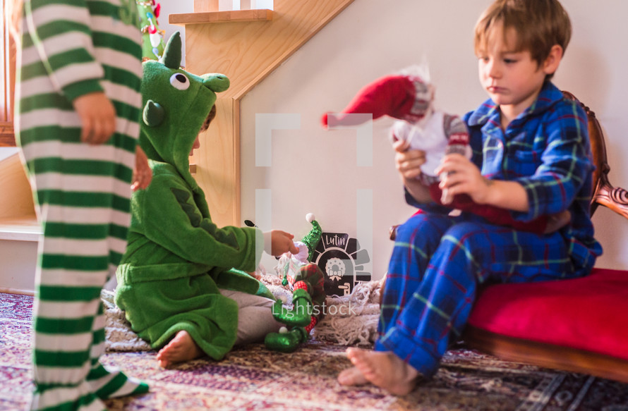 toddlers playing with Christmas decorations 