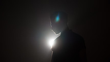 man standing in a spotlight 