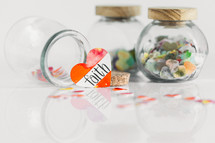 Jars of paper hearts on a white background with one lettered FAITH in front.