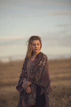 a young girl with blanket scarf in the evening sun
