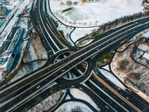 aerial view over a snowy city and highways 