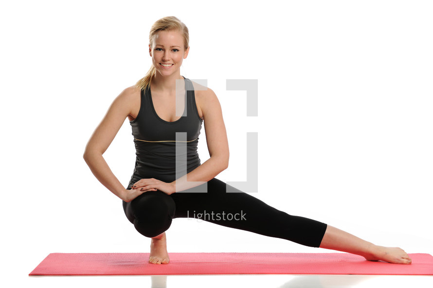 woman on a yoga mat stretching 