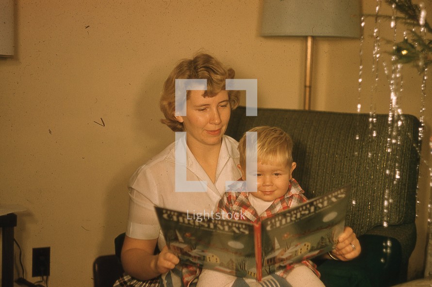 a mother reading her son a Christmas story 