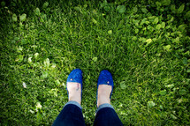 blue shoes in green grass 
