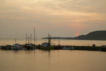 boats docked at sunset