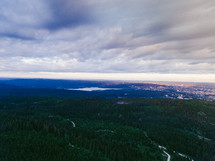 aerial view over a mountain forest and lake 