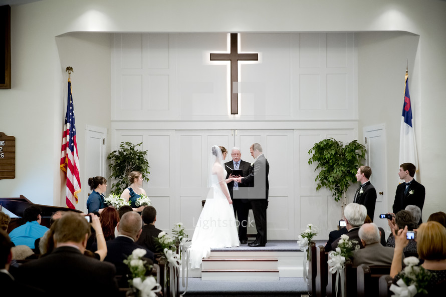 bride and groom exchanging vows in a church during a wedding ceremony 