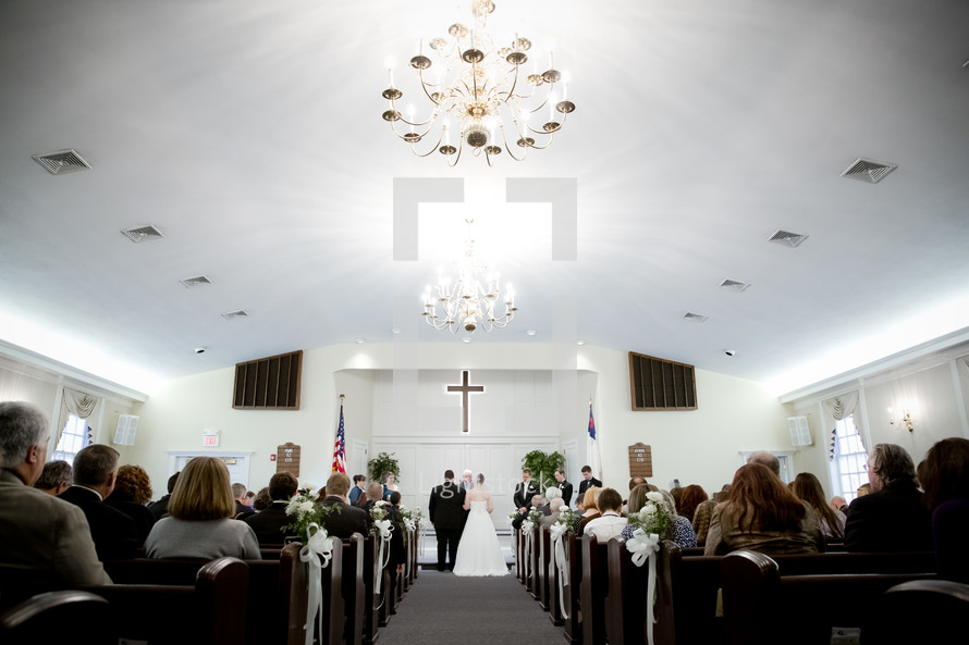 bride and groom exchanging vows in a church