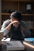 Woman praying with a Bible