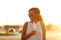 a woman holding an ice cream cone 