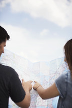 man and woman pointing to a map 