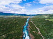 aerial view above a river with rapids 