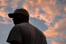 a man standing outdoors at sunset 