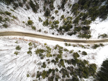 aerial view over a road in the snow 