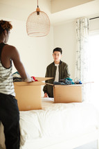 teen boys packing moving boxes 