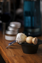 Set of shaving equipment and men's cosmetic products on wooden table, barbershop. shave concept with a straight razor, shaving brush and foam. beard care products for men on background