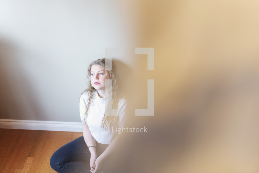 young woman sitting in room