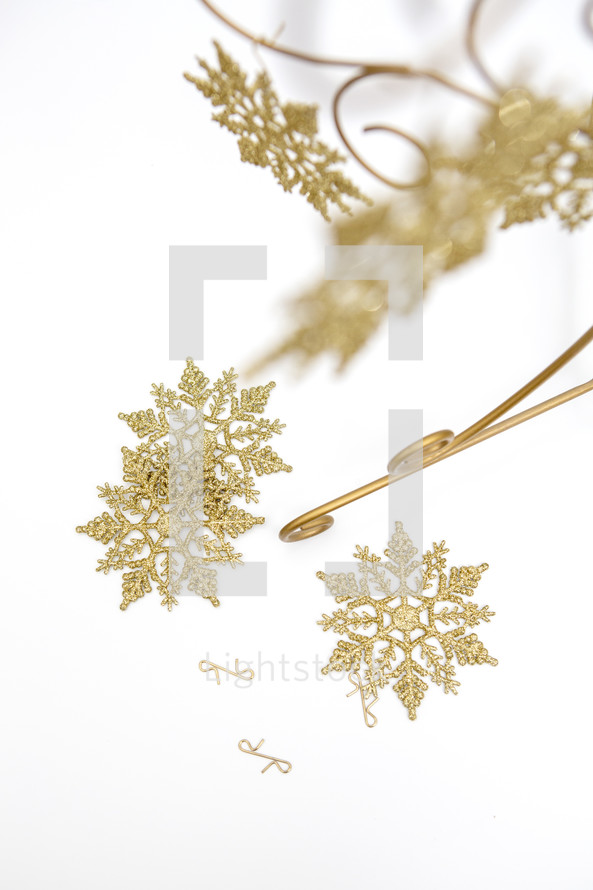 Gold snowflake decorations on white background