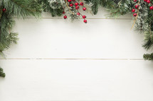 pine garland and berry bordered background.