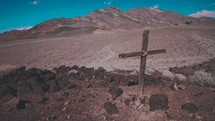 cross in a desert mountain landscape 