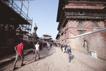 people walking cobblestone streets in Tibet 