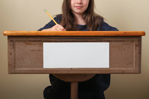 student sitting at her desk 