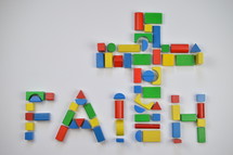 word faith cross of colorful toy wooden blocks 