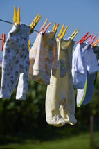 baby clothes drying at a laundry line. birth, birth announcement, 