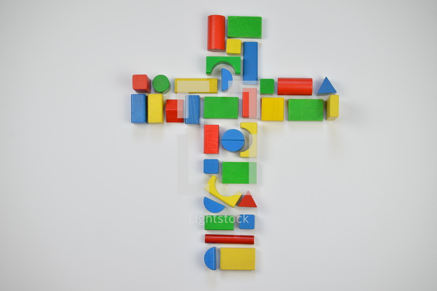 cross of colorful toy wooden blocks 