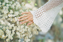 hands touching flowers 